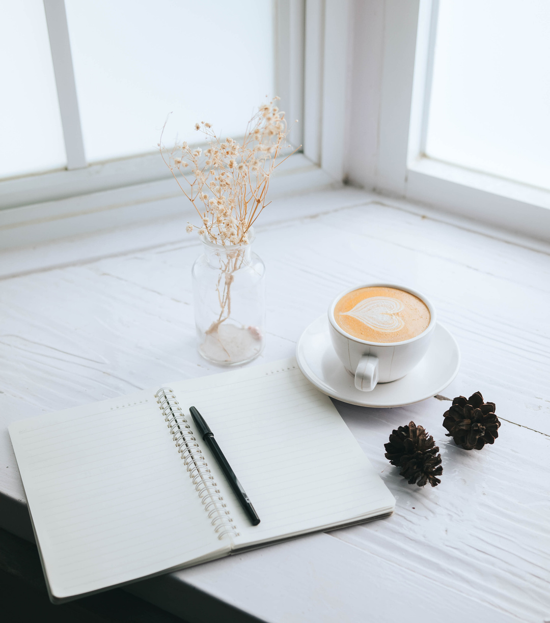 Notebook and Coffee on a Table